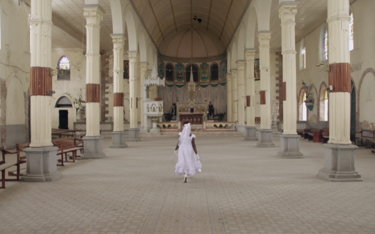 A figure in white stood inside a religious building