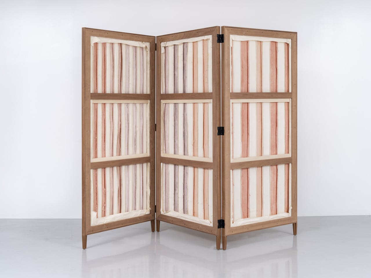 Image of a wooden folding screen with material panels
